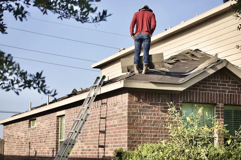 Professional roofer working on a residential roof in Marumsco Woods